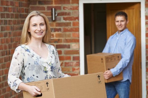 Loading furniture and boxes into a van on a residential street in Richmond upon Thames
